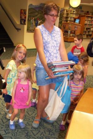 Family checking out books